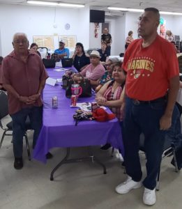 Two men standing in crowd for San Antonio Purple Heart Recipients Celebration